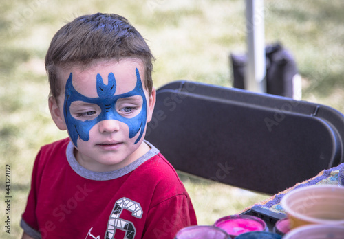 young boy with blue face paint