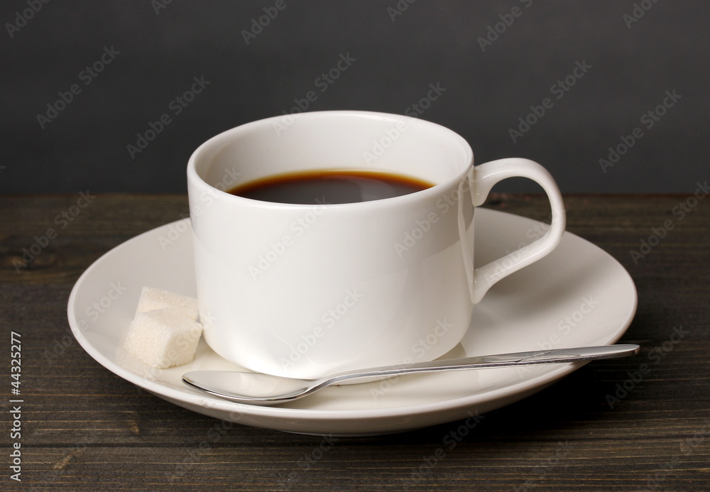 Coffee cup on wooden table on grey background Coffee cup on wooden table on grey background