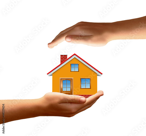 The house in hands isolated on white background