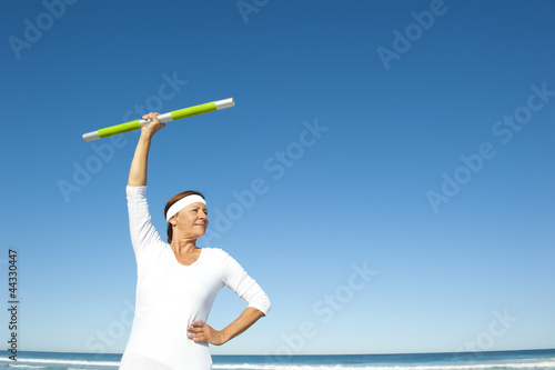 Active senior woman ocean background