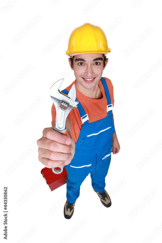 Young worker with adjustable spanner Young worker with adjustable spanner