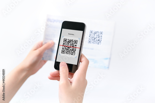 Woman scanning QR code in the magazine