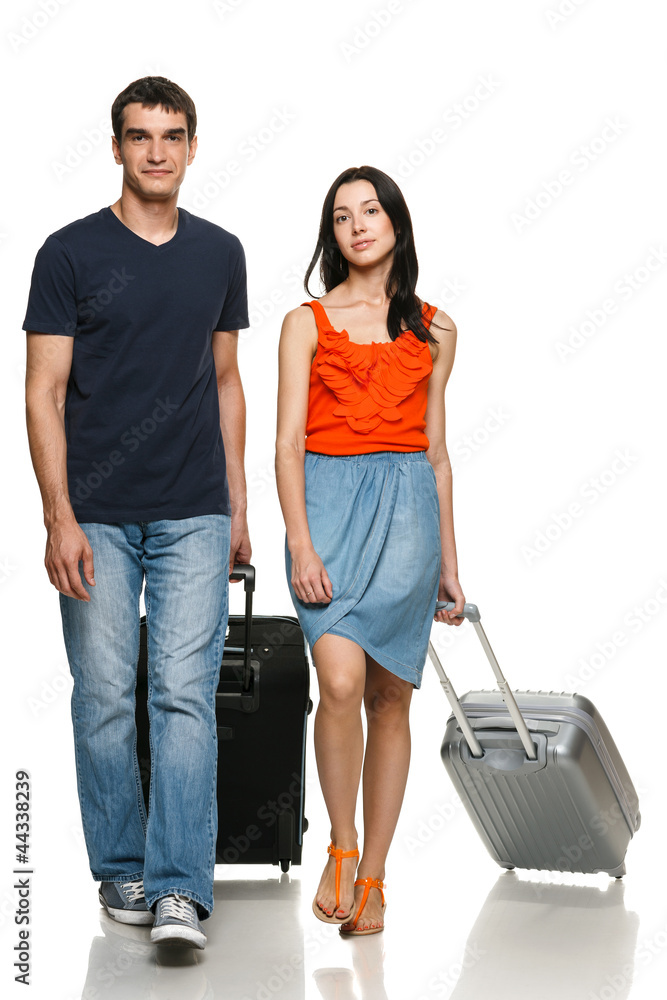 Full length of young couple walking with travel suitcases Full length of young couple walking with travel suitcases