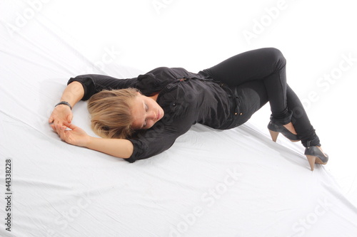 Blonde woman lying on white floor