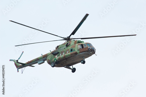 Fototapeta Naklejka Na Ścianę i Meble -  Russian military helicopter MI-8 in the cloudy sky