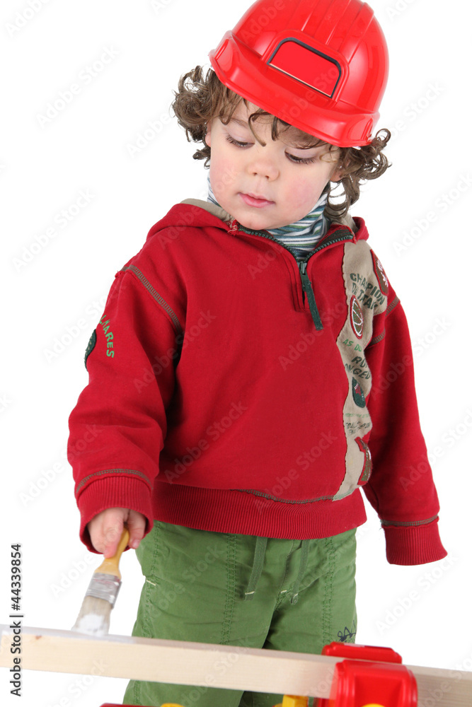 cute toddler with red plastic helmet painting cute toddler with red plastic helmet painting