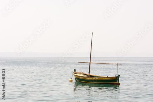 Fishing boat with a mast in sea