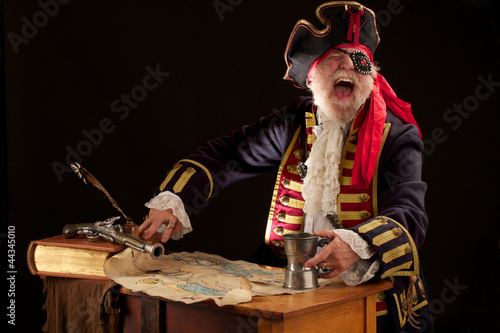 Laughing pirate captain with treasure map. photo