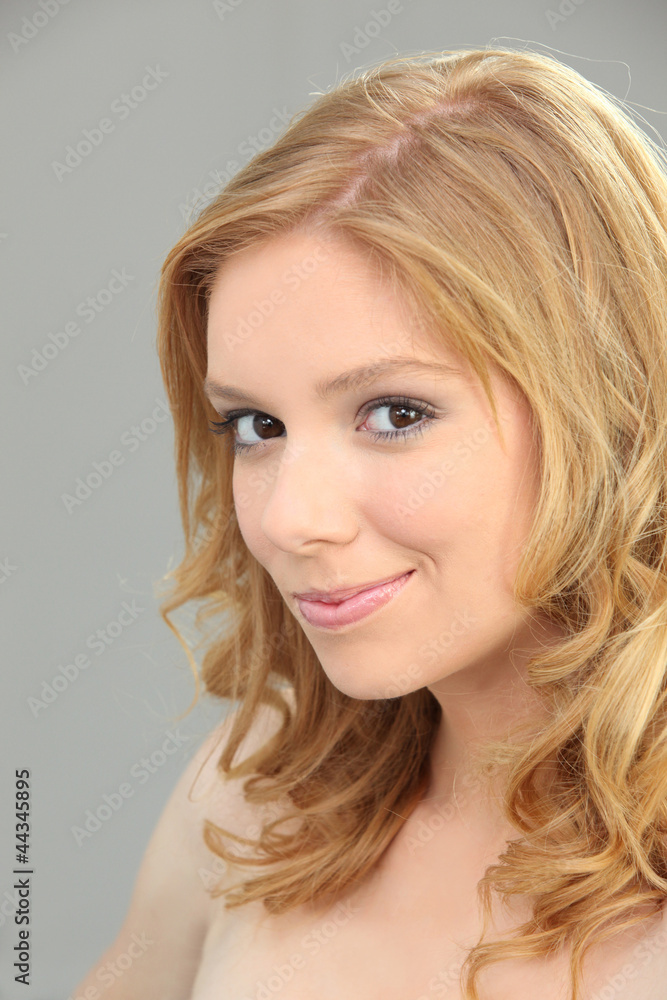 Young blond woman with shy smile Young blond woman with shy smile