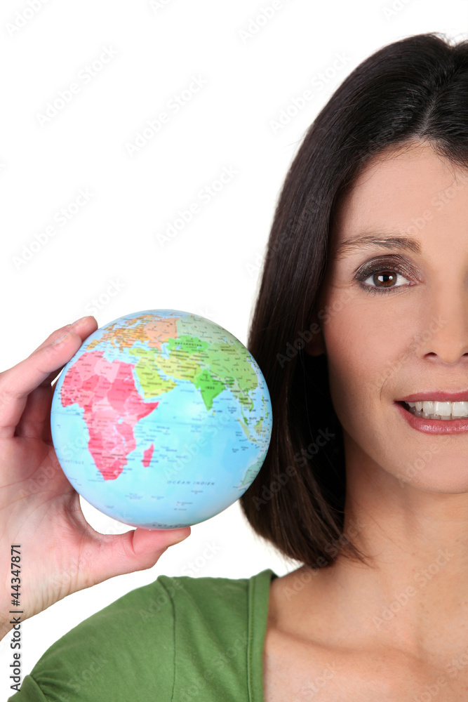 young woman taking a little globe in her hand young woman taking a little globe in her hand
