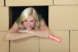 Woman surrounded by a wall of packing boxes