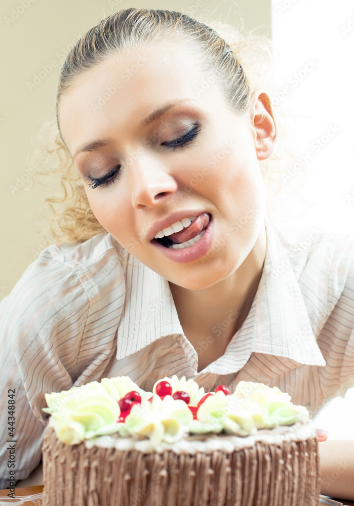 Cheerful blond young woman eating torte Cheerful blond young woman eating torte