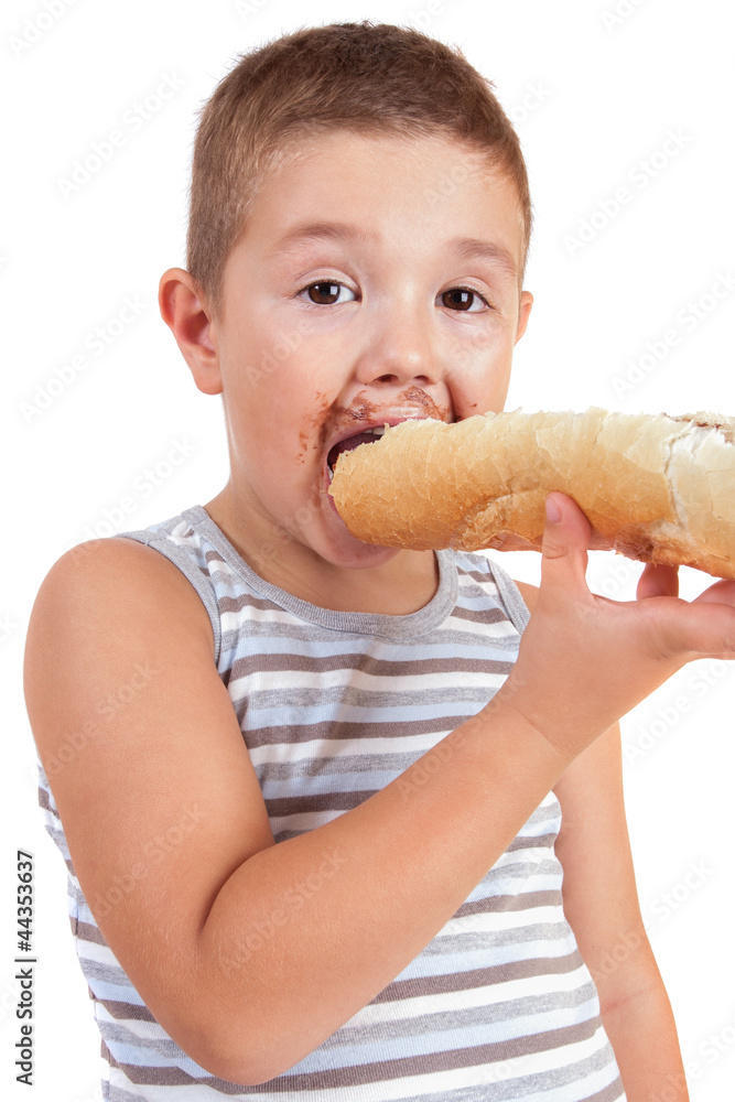 beautiful little boy eats bread with chocolate cream beautiful little boy eats bread with chocolate cream