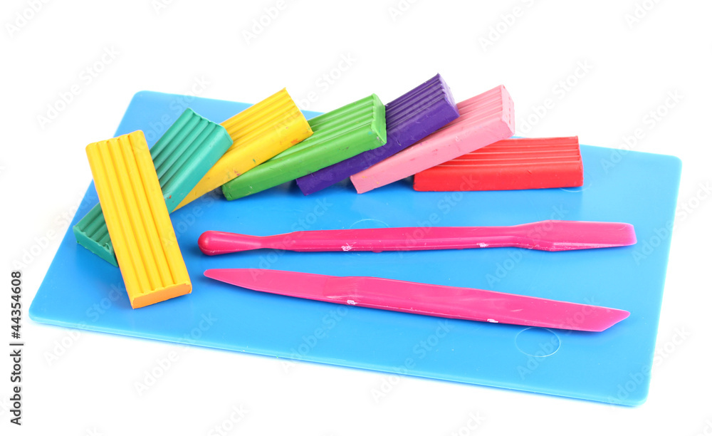 Children bright plasticine on desk with stacks isolated on Children bright plasticine on desk with stacks isolated on