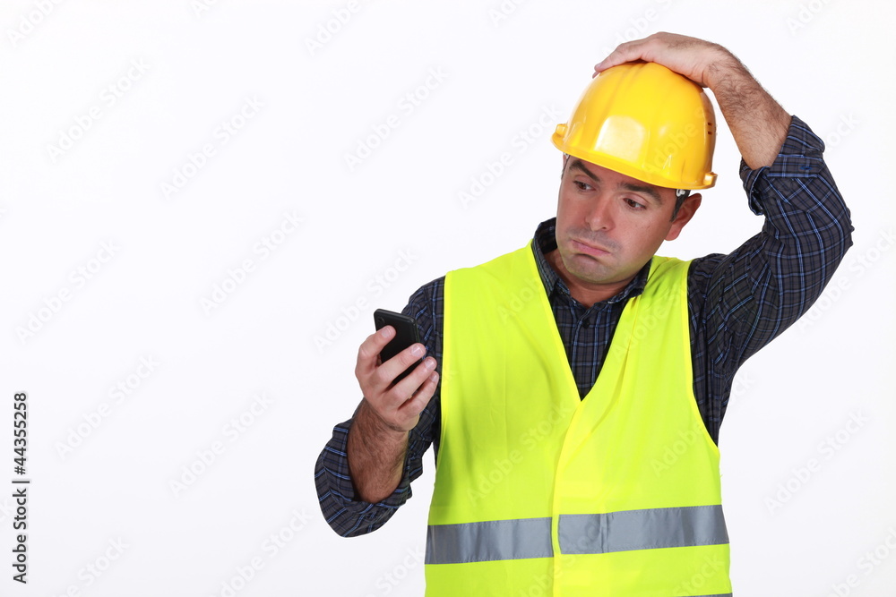 workman with fluorescent safety jacket looks puzzled workman with fluorescent safety jacket looks puzzled
