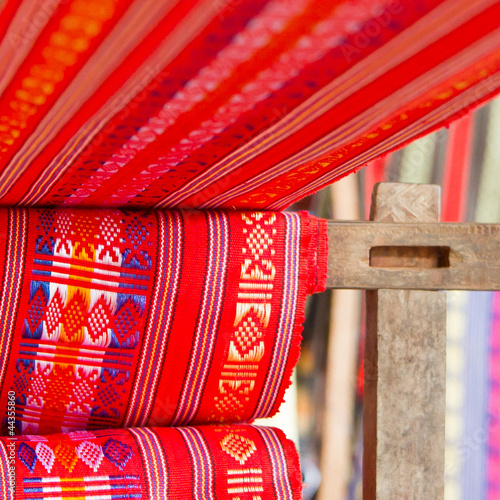 Handmade silk textile industry, silk scarf on a old machine photo