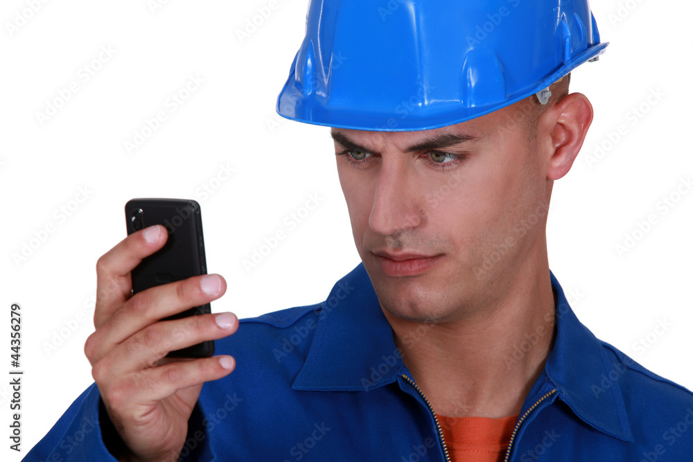 portrait of young blue collar reading sms portrait of young blue collar reading sms