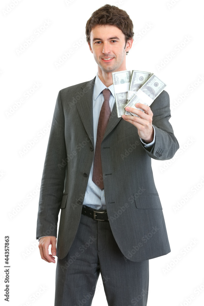 Smiling businessman showing packs of dollars Smiling businessman showing packs of dollars