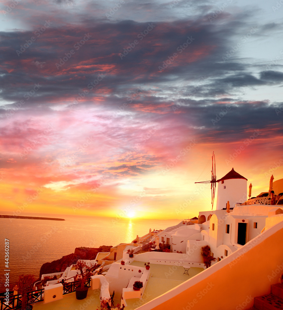 Santorini with windmill against sunset in Greece
