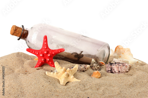 Glass bottle with note inside on sand isolated on white