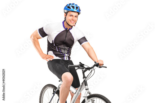 Male biker with helmet posing on a bike