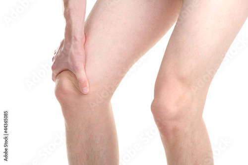 man holding sore knee  isolated on white