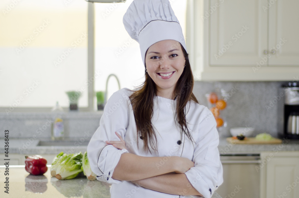 Beautiful female chef in a kitchen