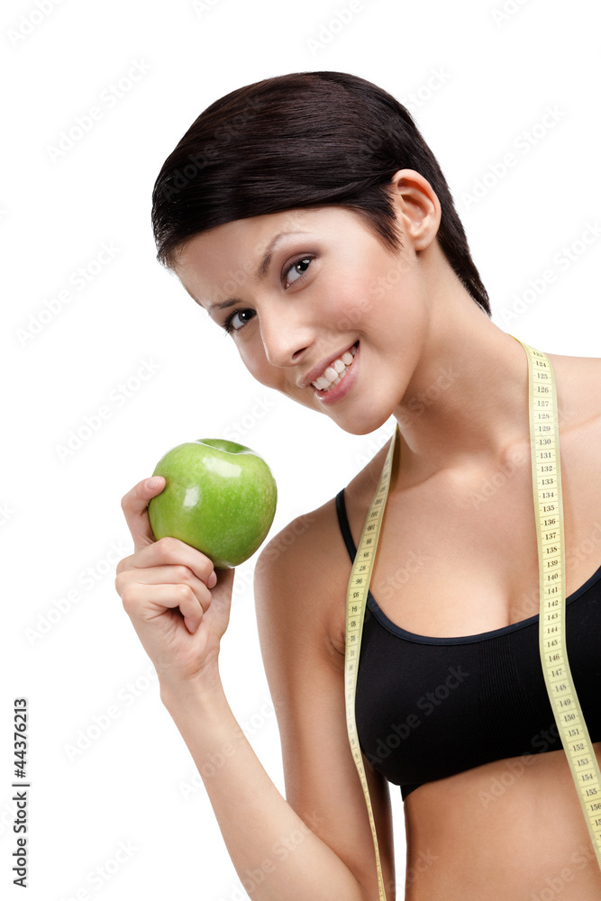 Indulging fitness woman with flexible ruler and green apple Indulging fitness woman with flexible ruler and green apple