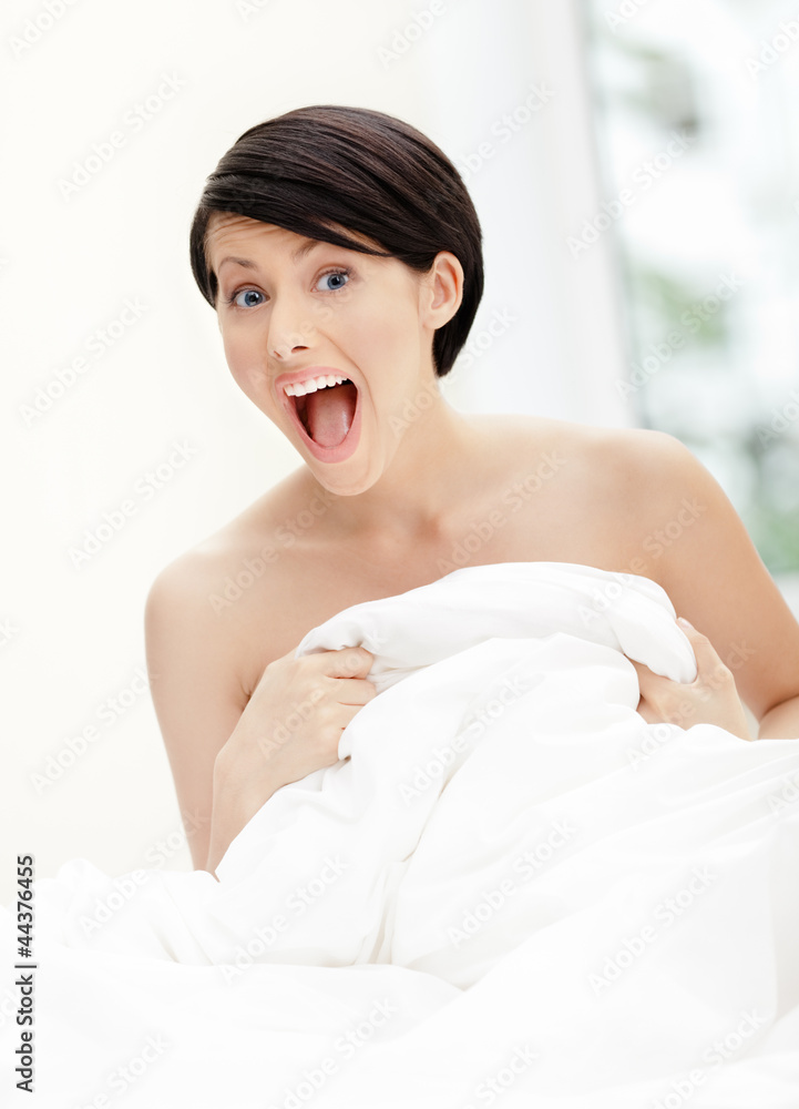 Halfnaked woman hugs the eiderdown, white background Halfnaked woman hugs the eiderdown, white background