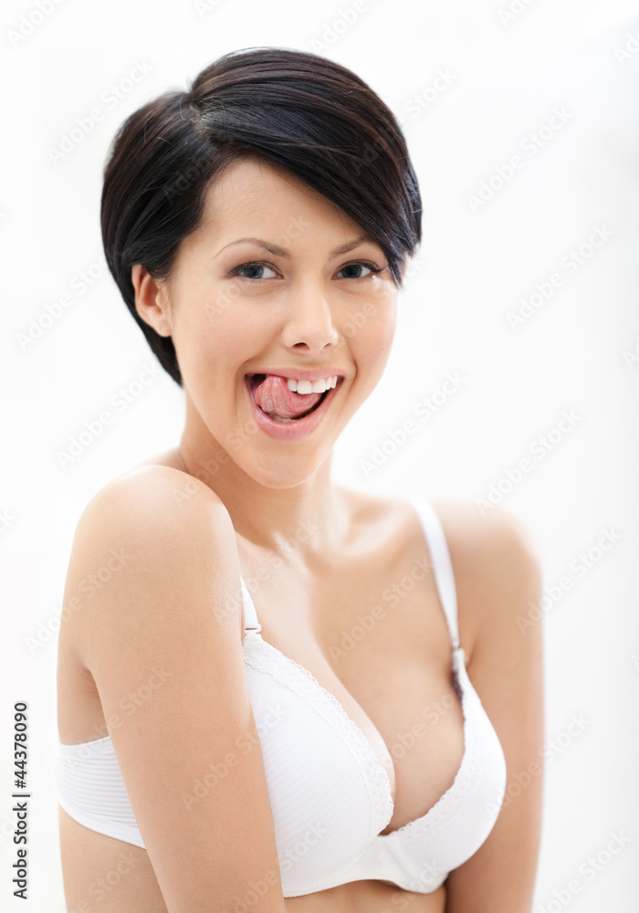 Portrait of woman in underwear putting out a tongue Portrait of woman in underwear putting out a tongue