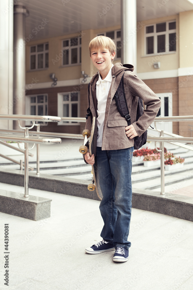 School teen with schoolbag and skateboard