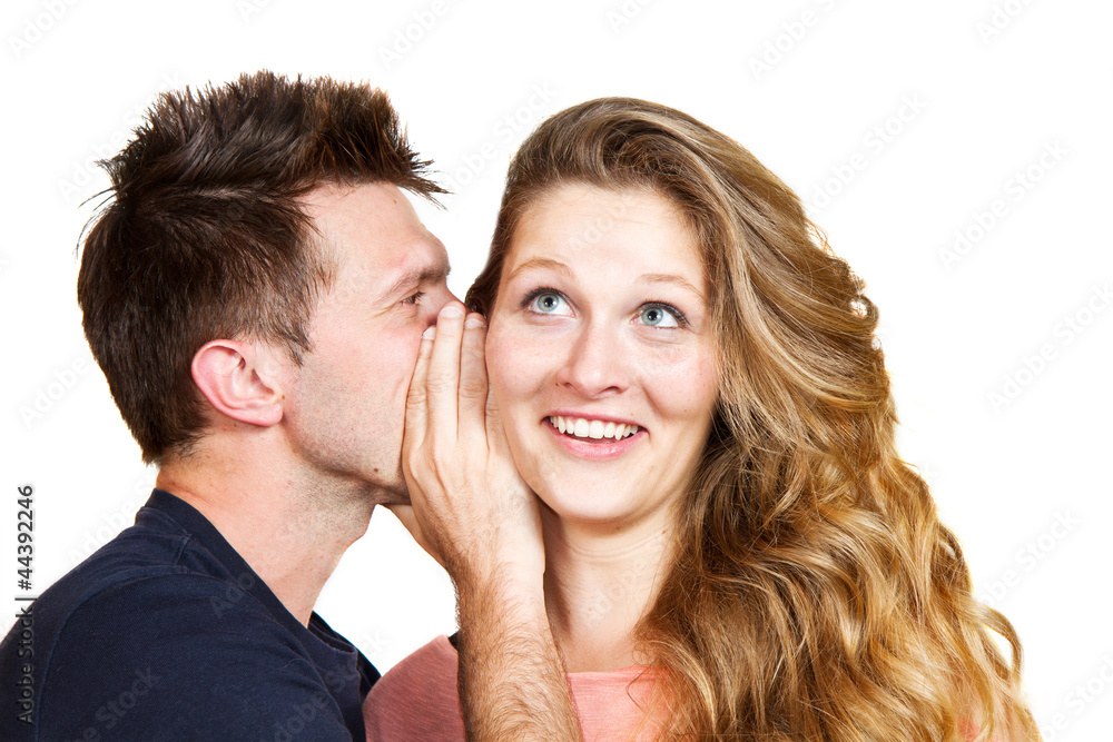 young man whispering a secret young man whispering a secret