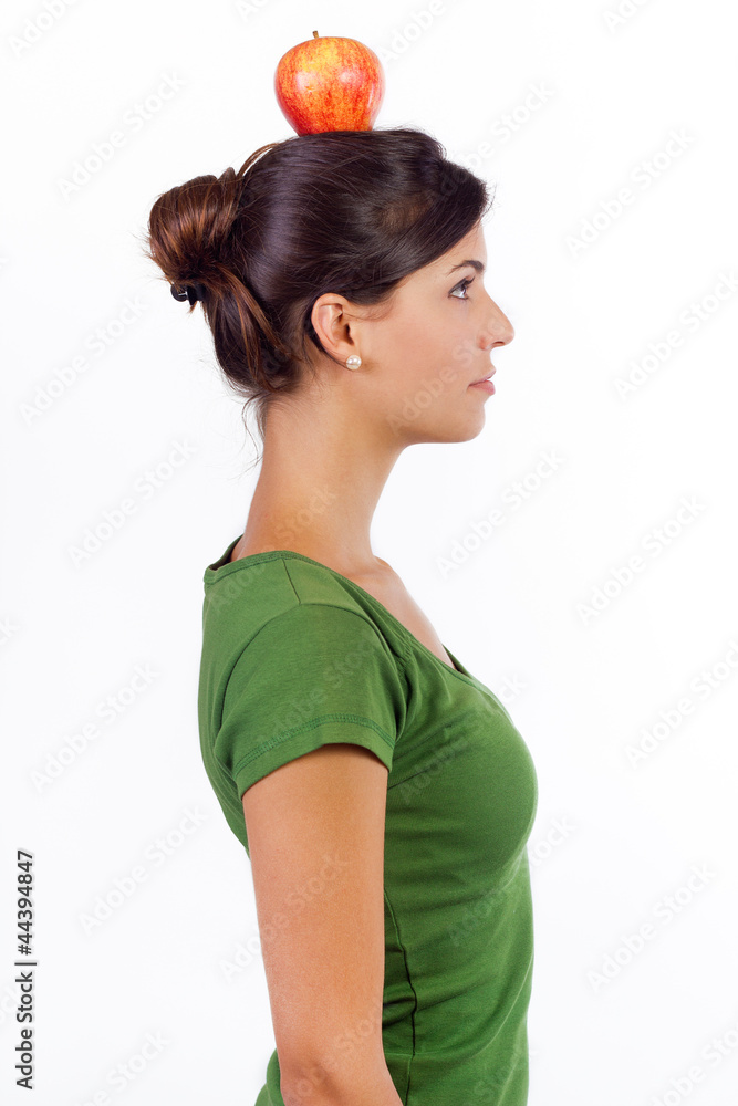 young woman holding an apple on her head young woman holding an apple on her head