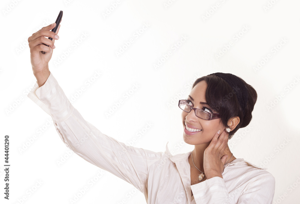Attractive woman takes a picture of herself with her phone. Attractive woman takes a picture of herself with her phone.