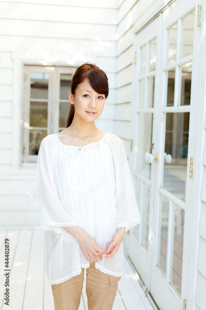 Beautiful young woman standing on terrace. Portrait of asian. Beautiful young woman standing on terrace. Portrait of asian.