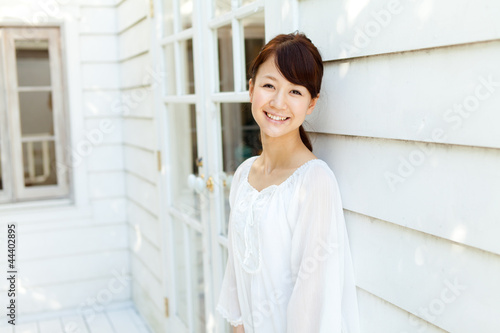 Free Download Beautiful young woman standing on terrace. Portrait of asian. - GFXLoad