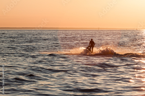 Young guy cruising in the baltic sea  on a jet ski
