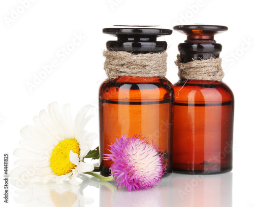 medicine bottles and flowers isolated on white