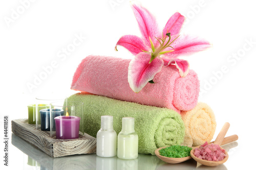 Fototapeta Naklejka Na Ścianę i Meble -  towels with lily, aroma oil,  candles and sea salt isolated