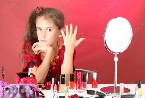 little girl in her mother's...
