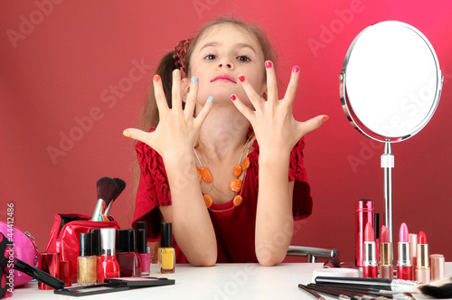 little girl in her mother's...