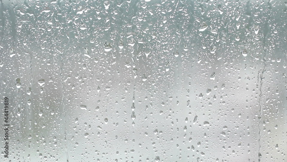 Drops of rain running down the glass Drops of rain running down the glass
