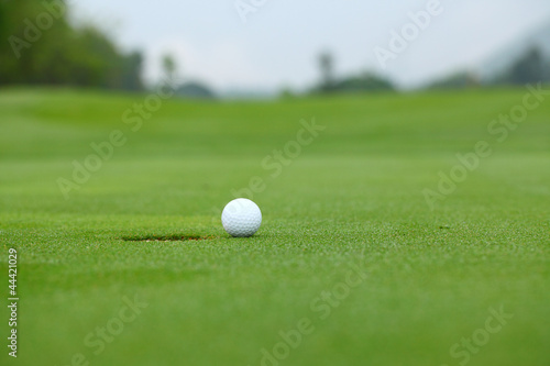 White golf ball near hole