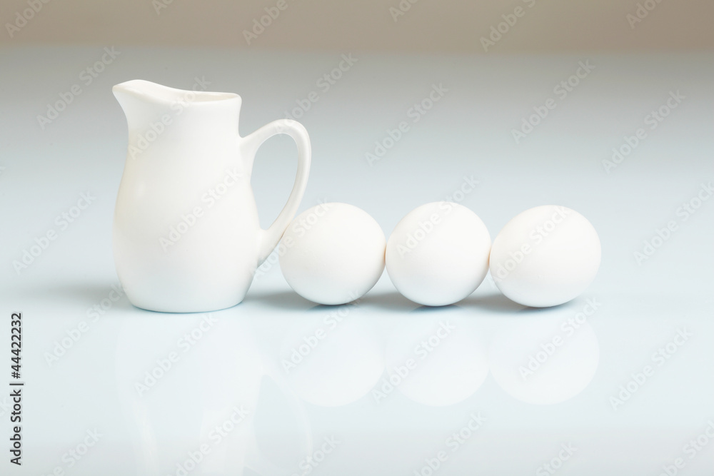 Milk in a glass jar and eggs Milk in a glass jar and eggs