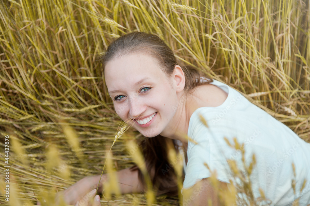 Portrait of beautiful smiling woman in the wheat field Portrait of beautiful smiling woman in the wheat field