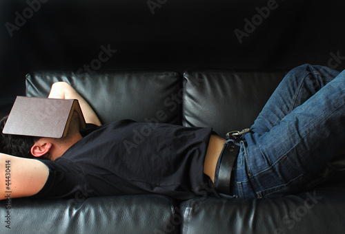 man with a book over his face
