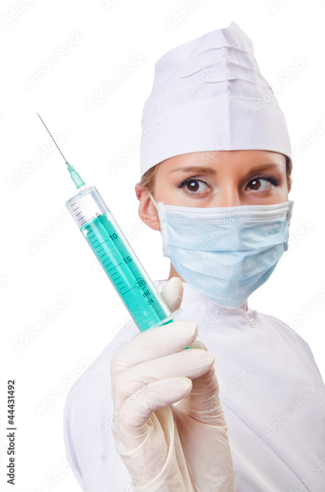 Woman doctor with syringe on white