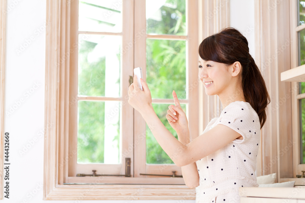 Beautiful young woman using a mobile phone. Portrait of asian. Beautiful young woman using a mobile phone. Portrait of asian.