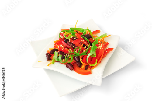 A salad of tomatoes, sweet peppers, red beans, carrots with sesa photo