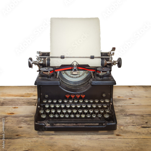 Old typewriter on a vintage wooden floor isolated on white